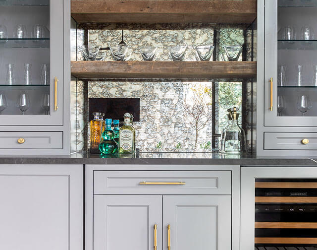 Carrara marble kitchen with luxury range and custom pot holder detail in Houston, TX