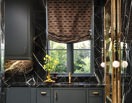 Dark marble kitchen with custom cabinets and luxury brass finishes detail in Houston, TX