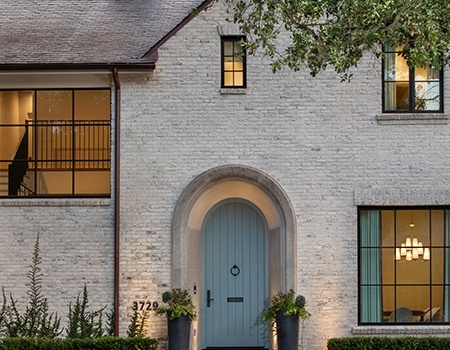 White washed brick iron windows and custom arched door Houston, TX