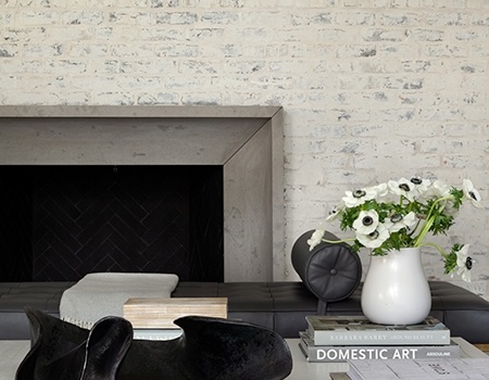 White Washed brick fireplace in a modern designed livingroom in Houston, TX