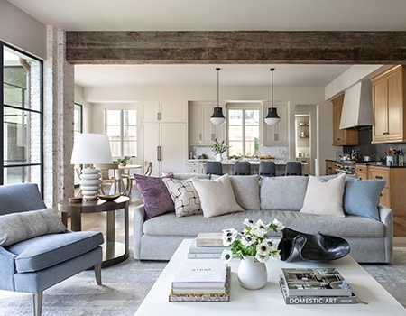 Living Room looking into a kitchen with exposed White Washed Brick and exposed wood beam in Houston, TX