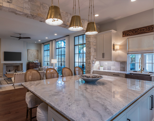 Carrara marble kitchen with farm house sink and iron windows in Houston, TX.